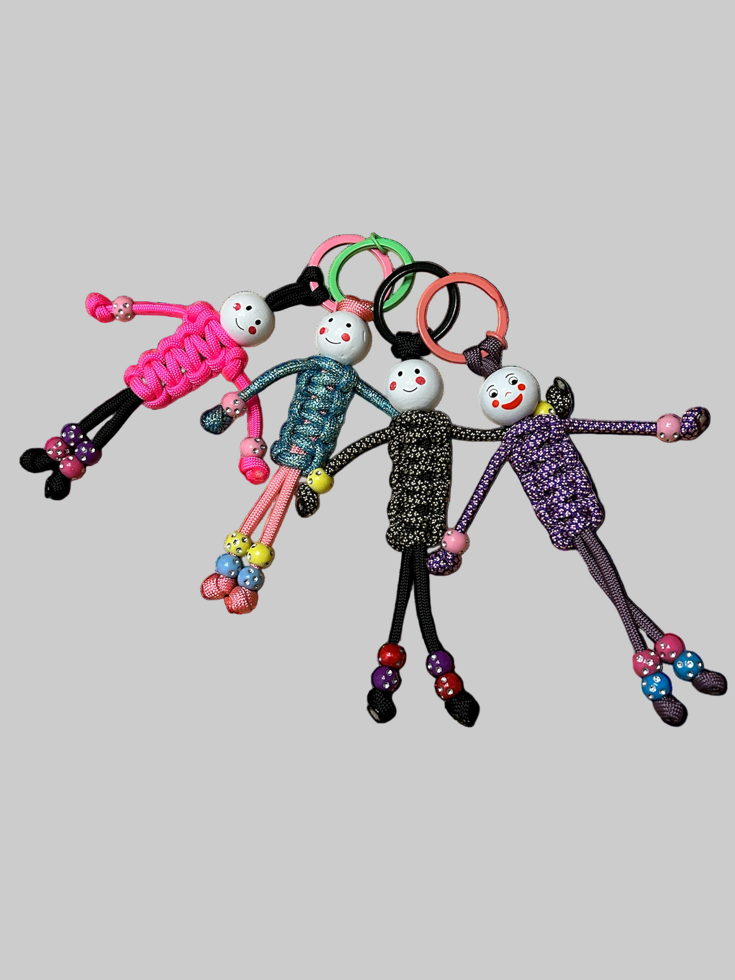 Multiple multi coloured paracord person key ring with wooden bead head