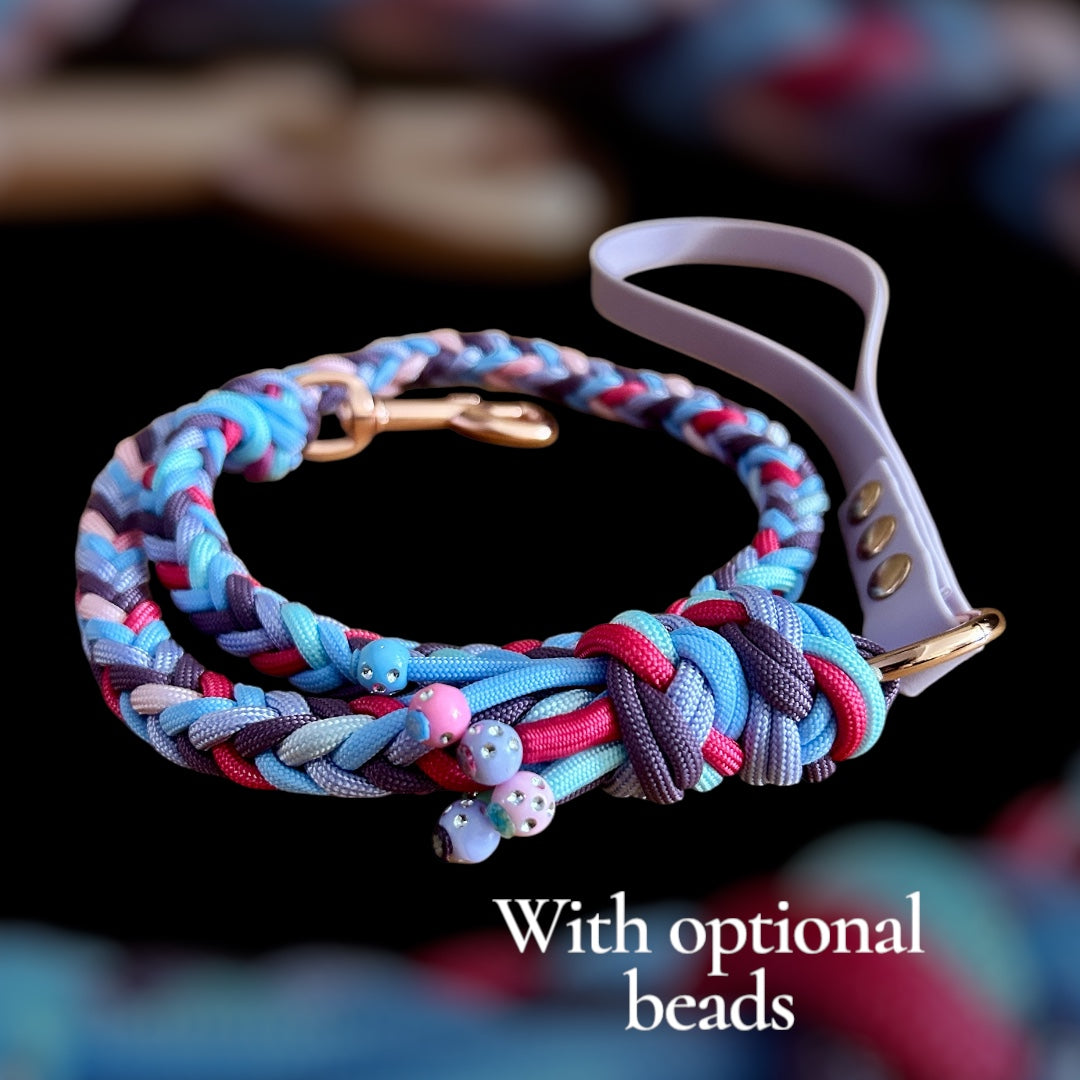 Colorful braided dog leash with optional beads on a blurred background