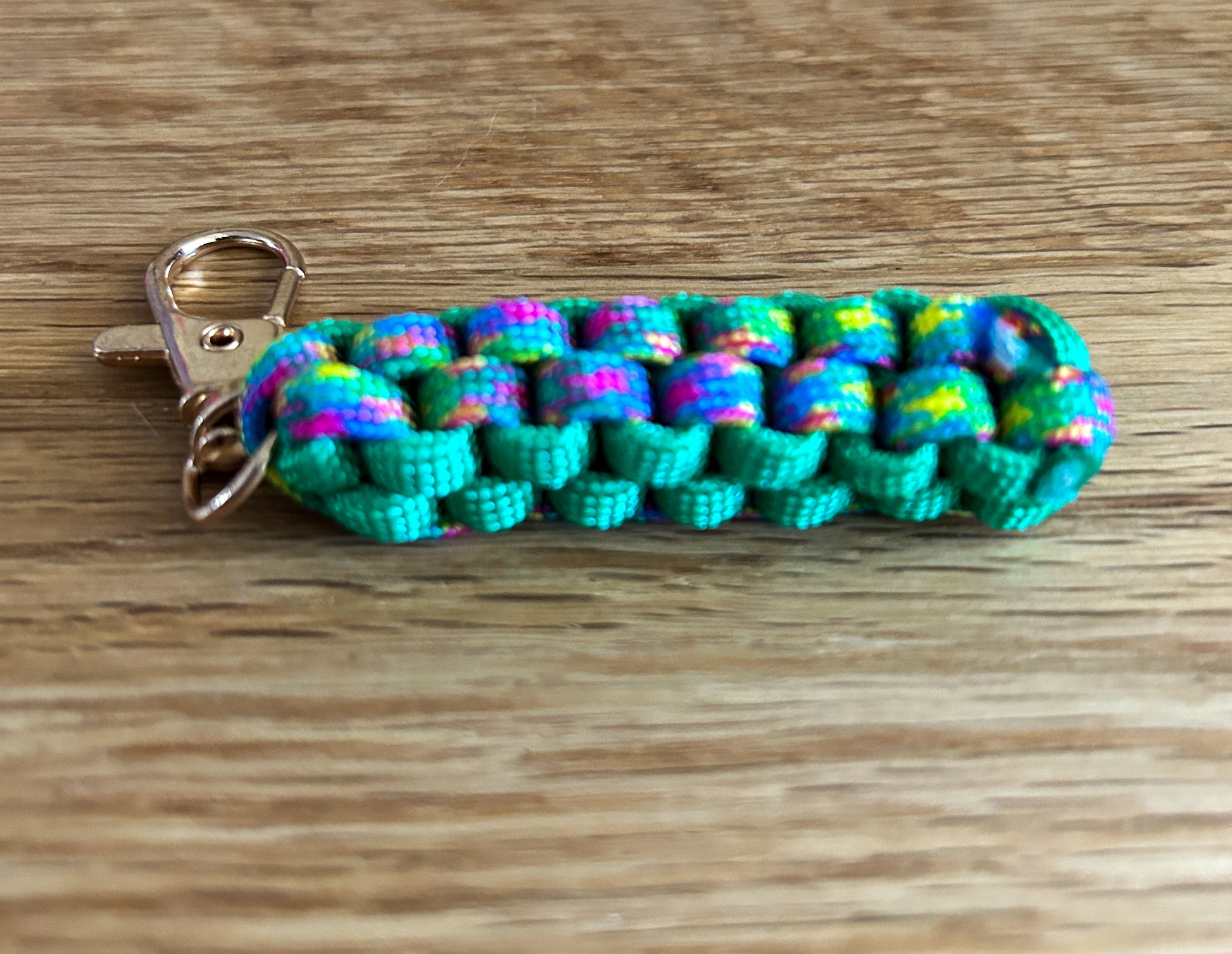 Colorful braided keychain on a wooden surface