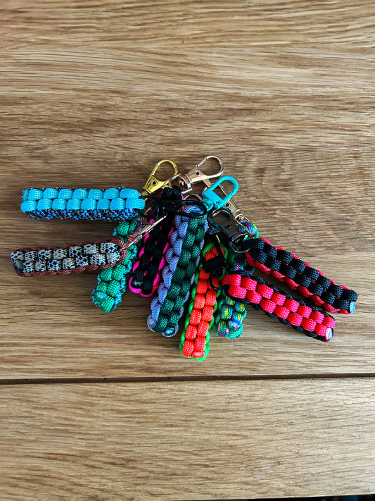 Colorful paracord keychains on a wooden surface