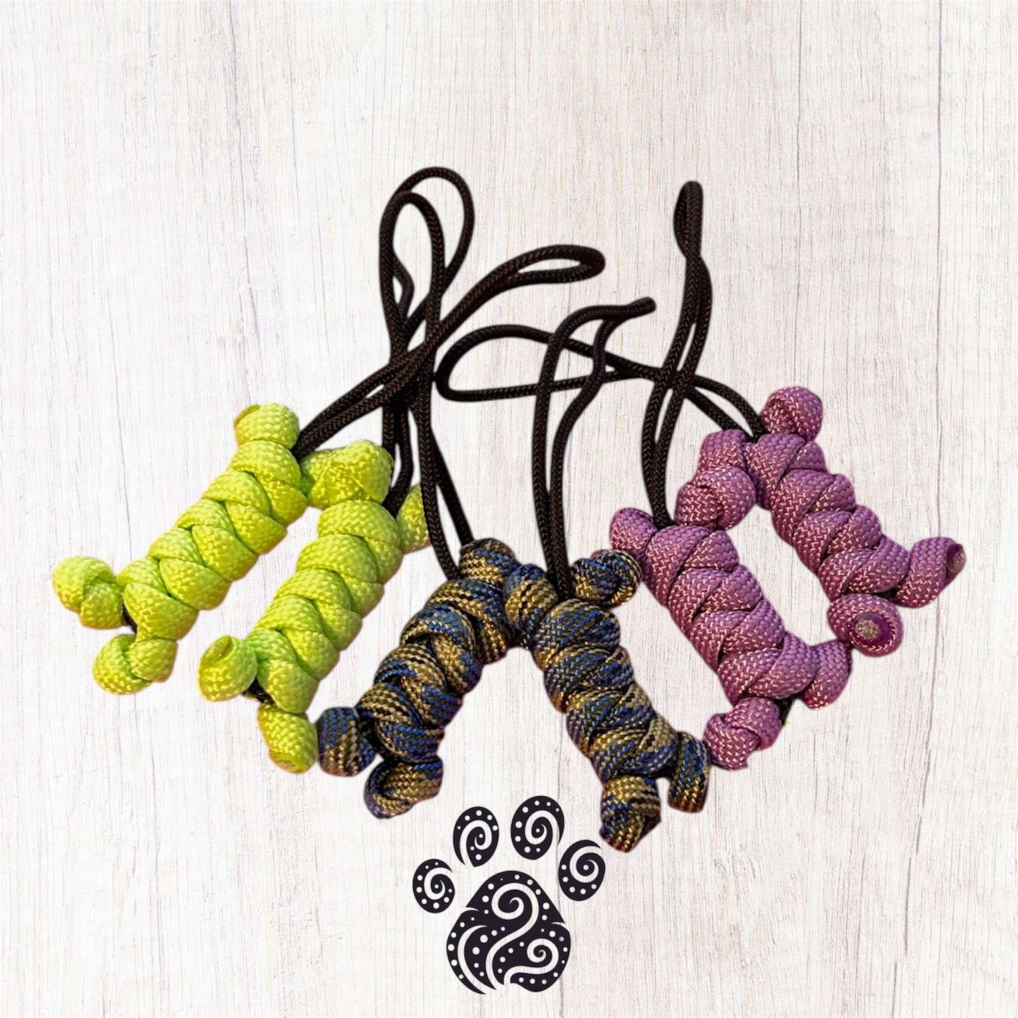 A set of multi coloured paracord zip pulls in the shape of a bone