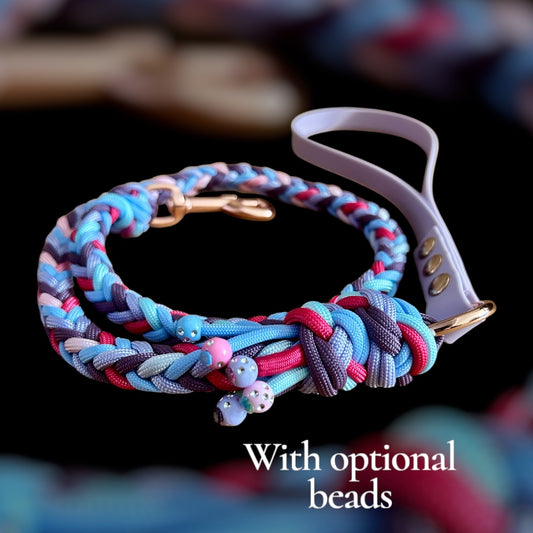 Colorful braided dog leash with optional beads on a blurred background