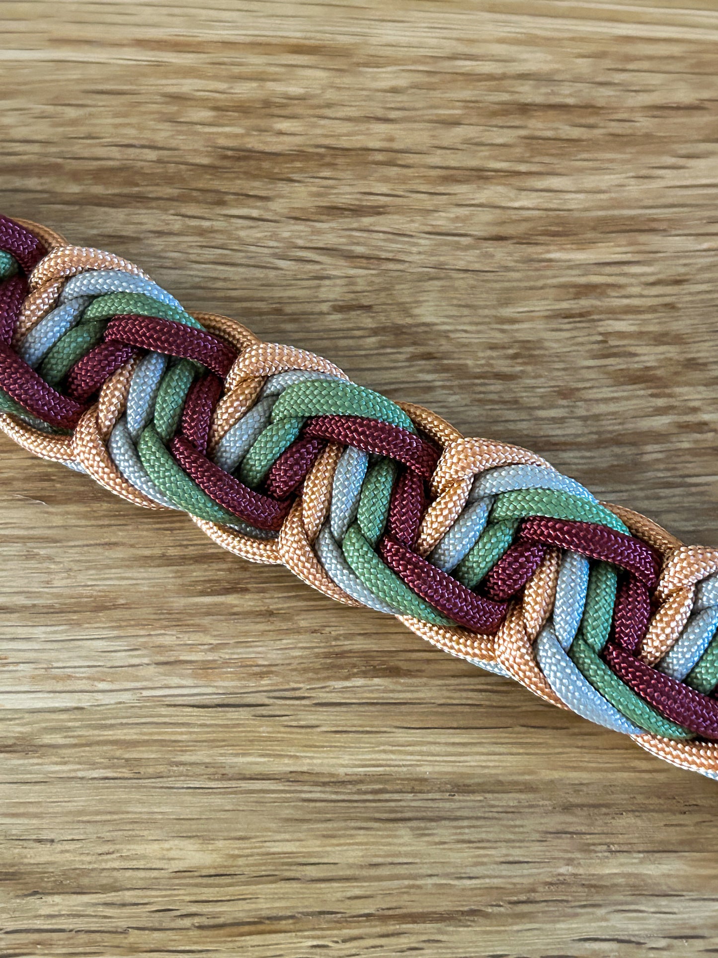 Multicolored braided cord on a wooden surface
